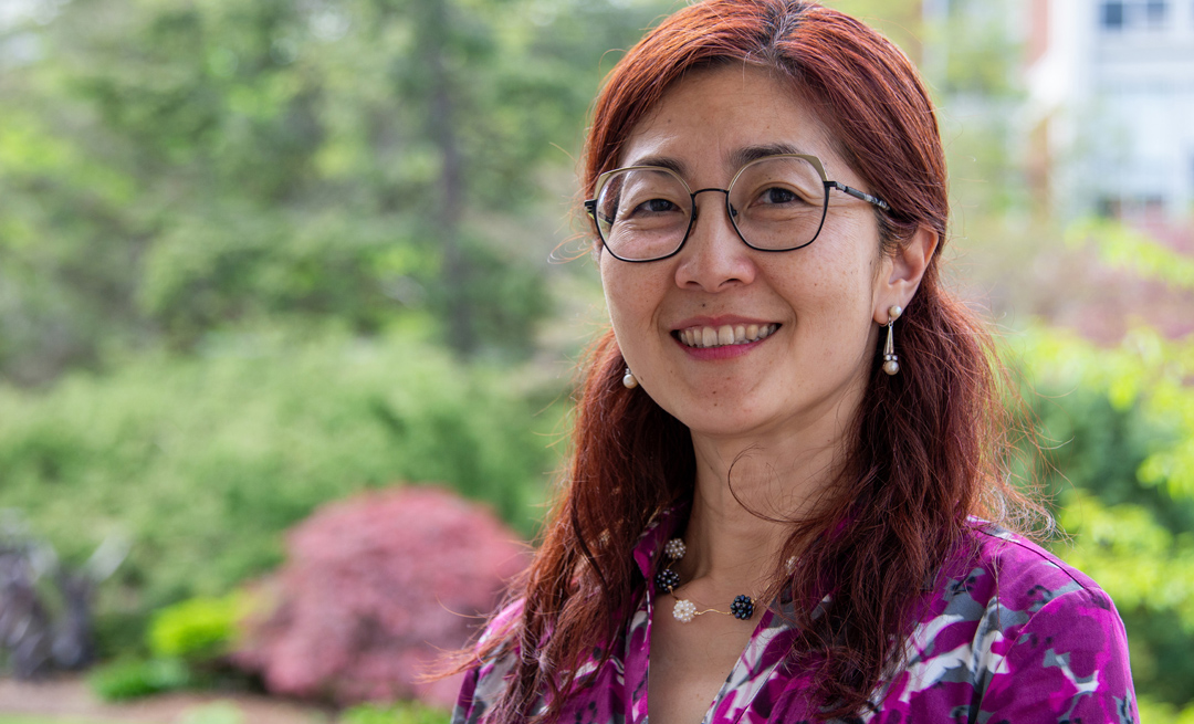 A professional headshot of an individual outdoors