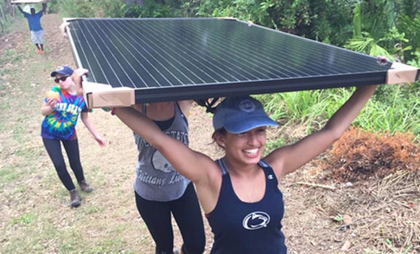 Penn State students carry solar panel
