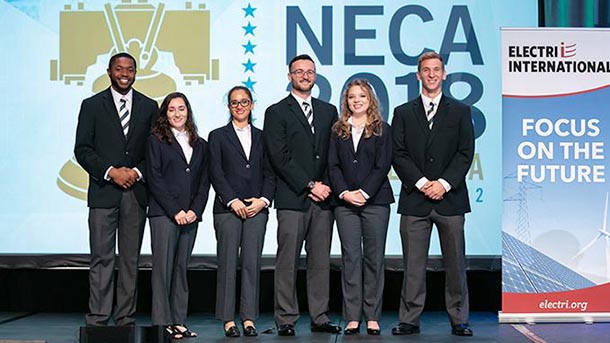 Students posing for a photo on a stage